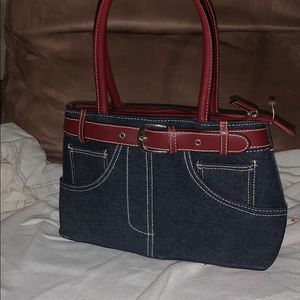 Denim tote bag with a deep red trim.